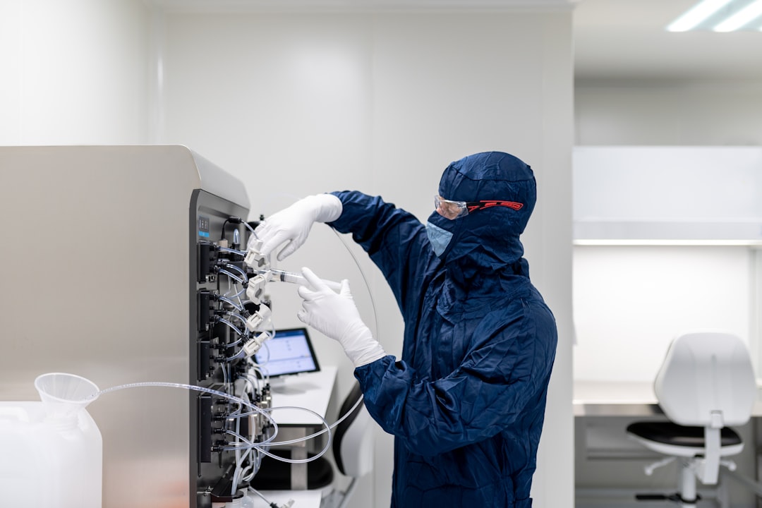 Biotech researcher operating advanced laboratory analysis equipment